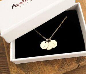 three gold initial pendant on gold chain