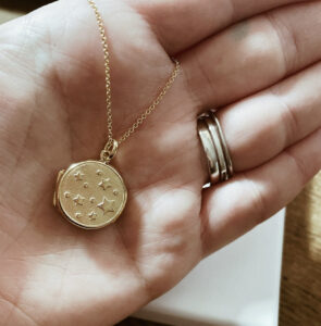 Gold locket necklace embossed with stars