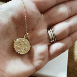 Gold locket necklace embossed with stars