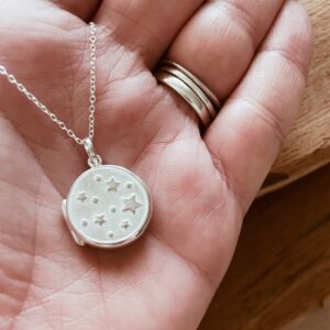 Silver star locket necklace. Sterling silver locket pendant, embossed with stars on a sterling silver trace chain. Photo necklace holds two photographs.