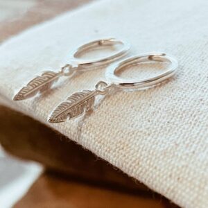 Sterling Silver dainty boho feather charm huggie hoop earrings.