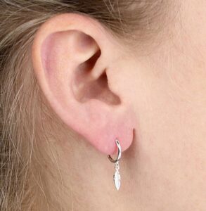Sterling Silver Feather Charm Huggie Hoop being worn.